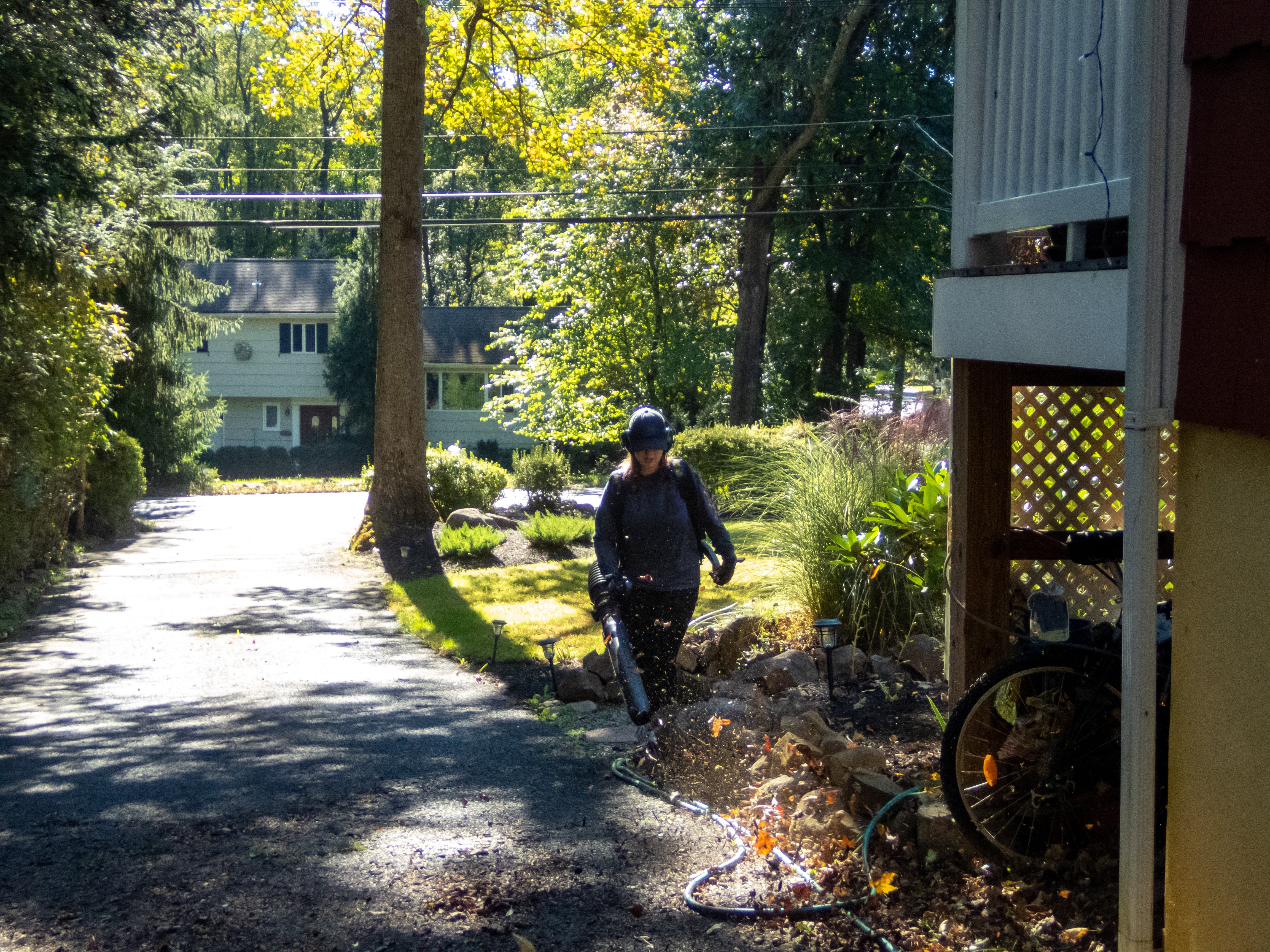 Worker using a commercial leaf blower to clear leaves. Schröder USA